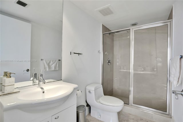 bathroom featuring tile patterned floors, vanity, a shower with door, and toilet