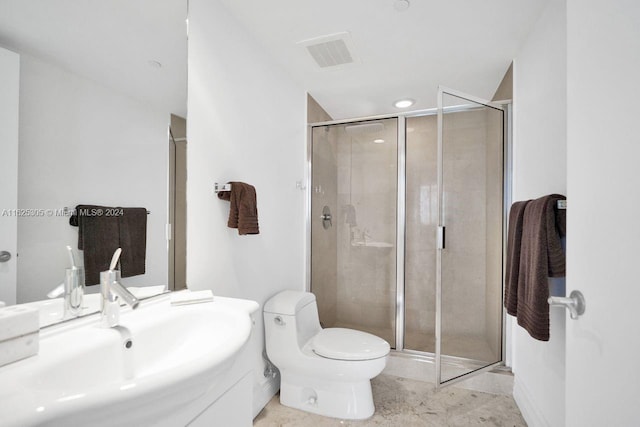 bathroom with vanity, walk in shower, tile patterned flooring, and toilet