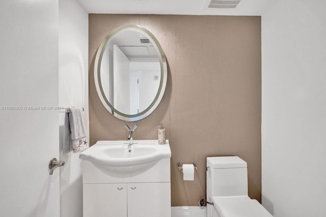 bathroom with toilet and vanity