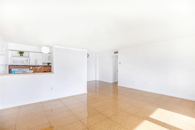 unfurnished living room with light tile patterned floors