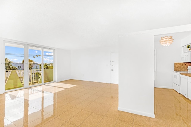 unfurnished room featuring light tile patterned floors and floor to ceiling windows