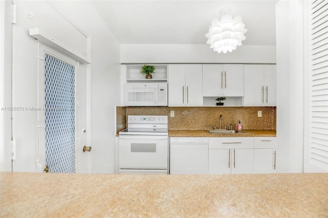 kitchen with tasteful backsplash, open shelves, a sink, white appliances, and white cabinetry