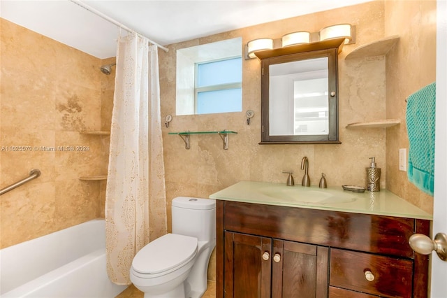 full bathroom with vanity, shower / bath combo, toilet, and tile walls