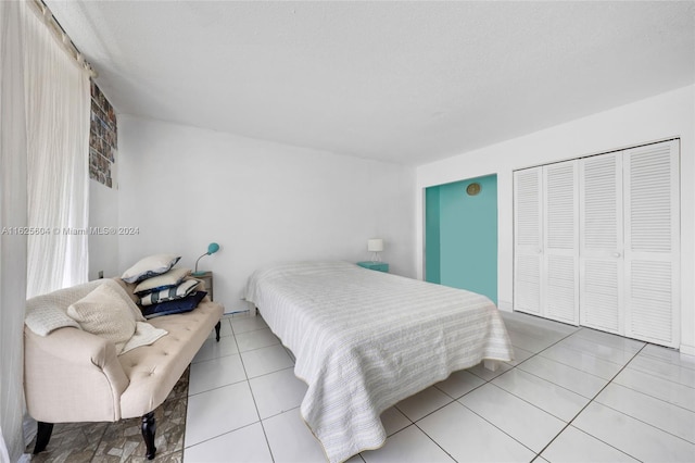 bedroom with a closet and light tile patterned floors