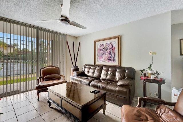 tiled living room featuring a textured ceiling and ceiling fan