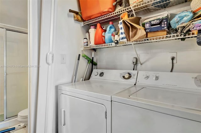 washroom with washing machine and clothes dryer