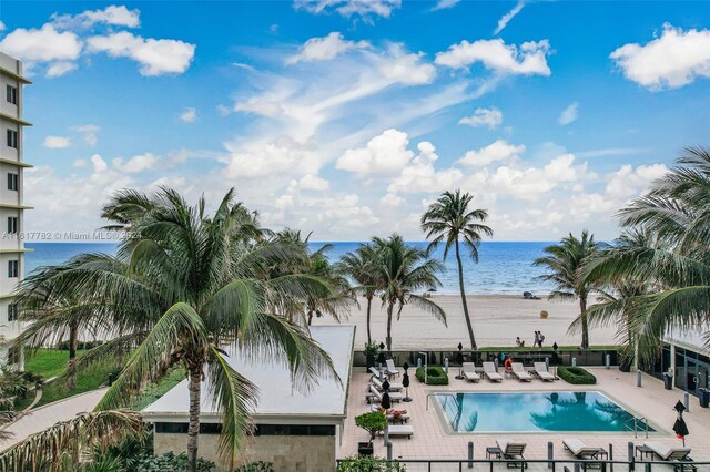 view of pool with a patio area and a water view