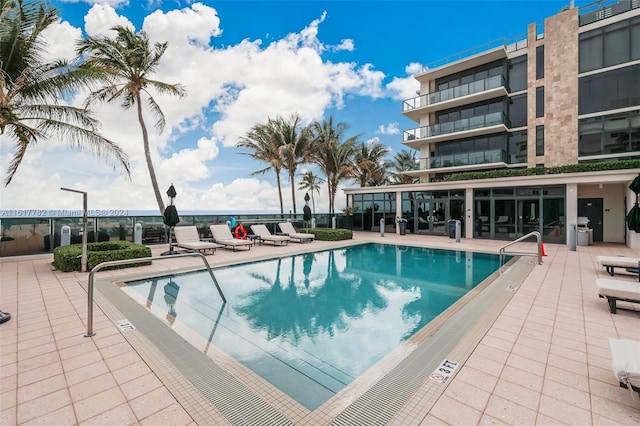 view of swimming pool featuring a patio area