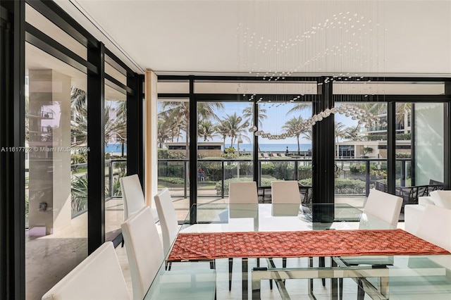 unfurnished sunroom with a water view and a healthy amount of sunlight