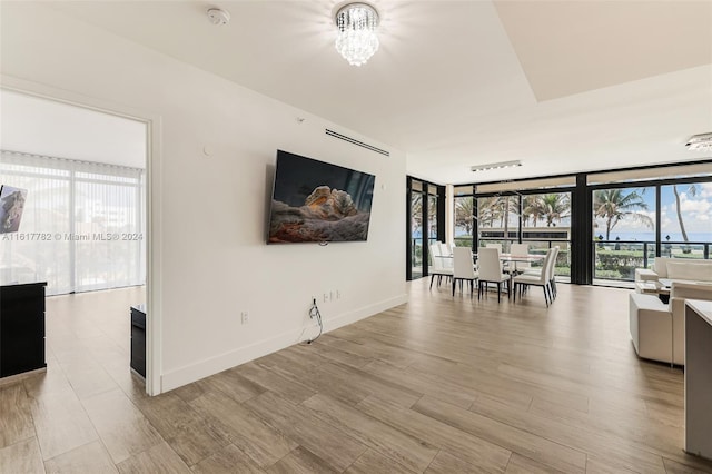 interior space with a wall of windows and an inviting chandelier