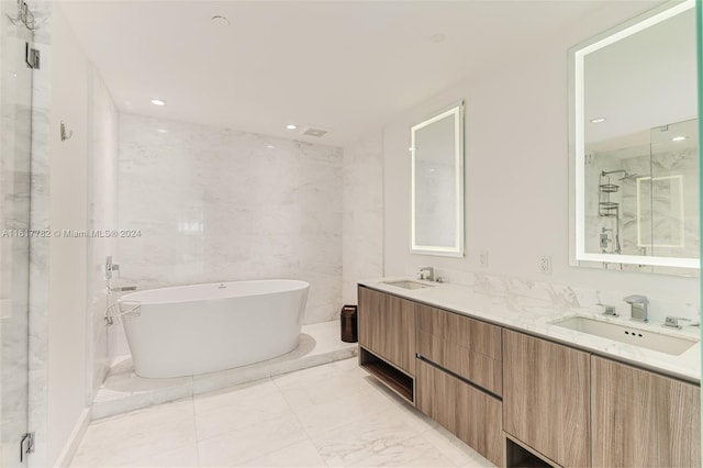 bathroom featuring vanity, tile walls, and shower with separate bathtub