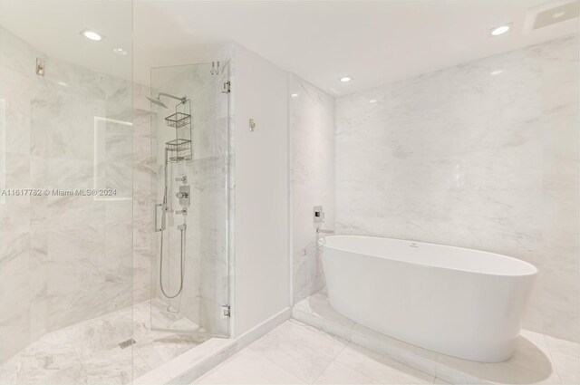 bathroom with separate shower and tub