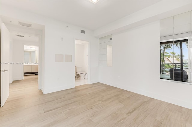 unfurnished room with light hardwood / wood-style flooring