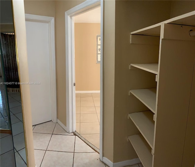 corridor featuring light tile patterned floors