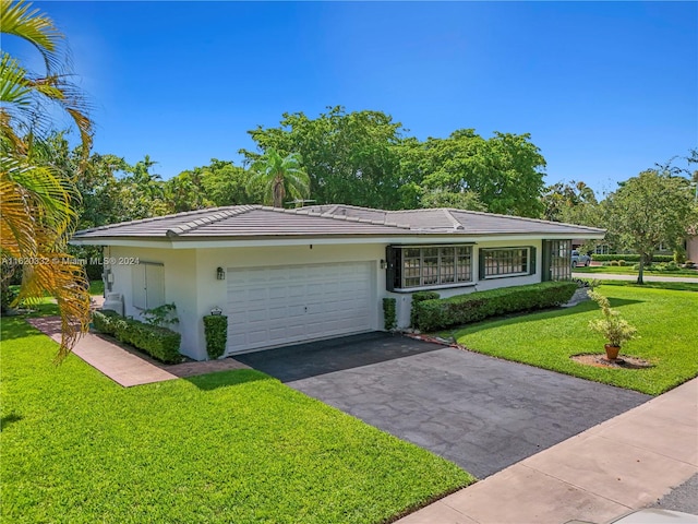 ranch-style home with a front lawn and a garage