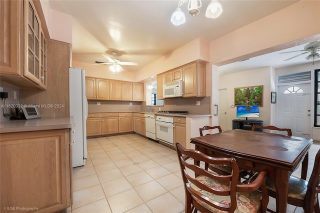 kitchen with white appliances, decorative light fixtures, light brown cabinets, and ceiling fan with notable chandelier