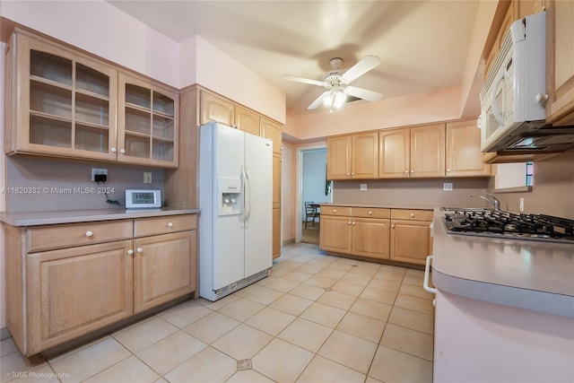 kitchen featuring light tile patterned floors, light brown cabinets, white appliances, and ceiling fan