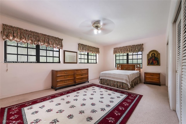 bedroom with carpet flooring, a closet, and ceiling fan