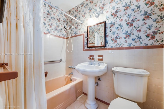 bathroom featuring toilet, shower / bath combo, tile walls, and tile patterned flooring