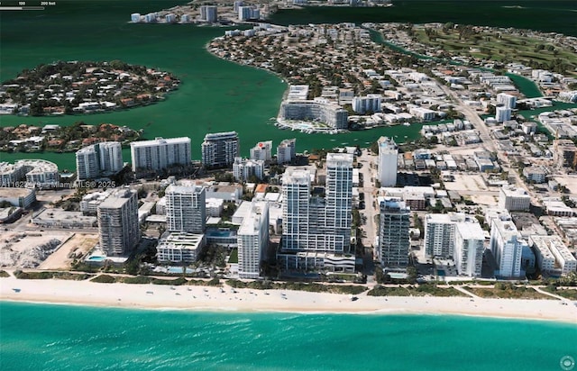 birds eye view of property with a view of the beach and a water view