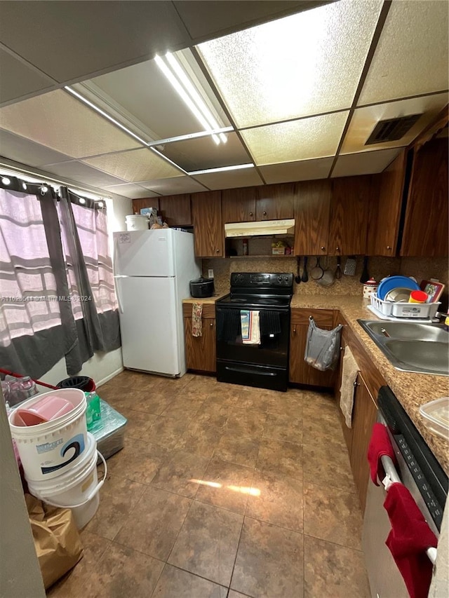 kitchen with sink, light tile patterned floors, black / electric stove, dishwasher, and white fridge