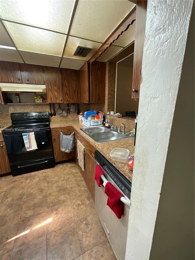 kitchen with light tile patterned flooring, dishwasher, black range with electric stovetop, a paneled ceiling, and sink