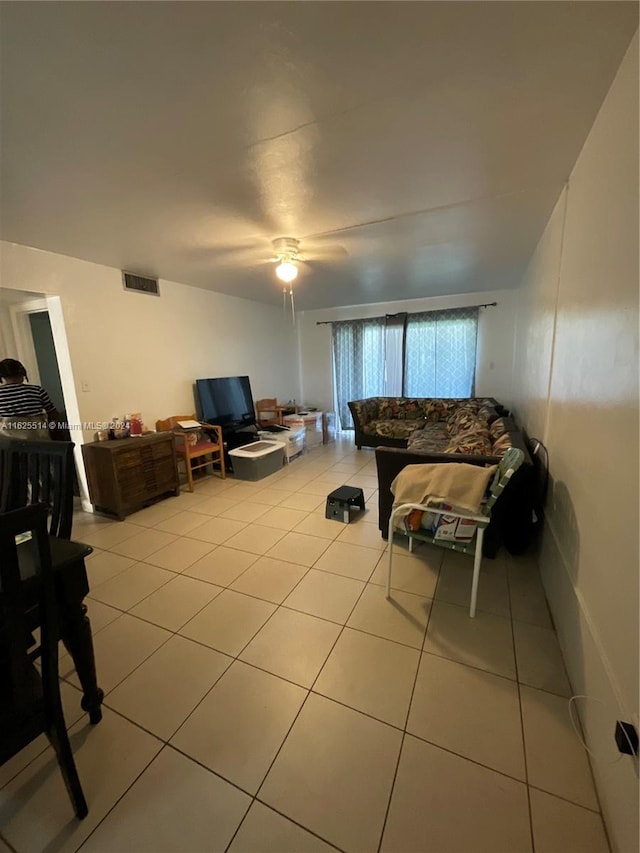 living room with ceiling fan and light tile patterned floors