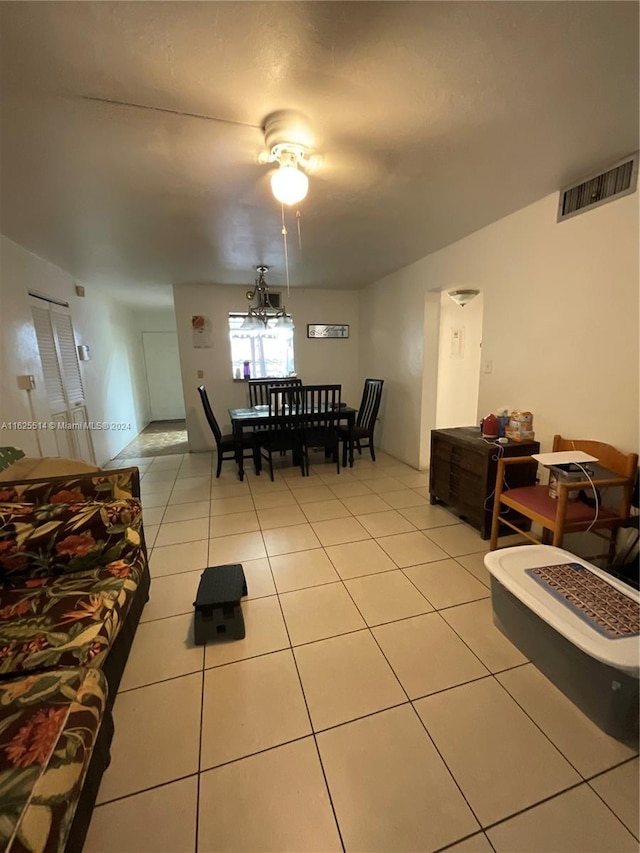 tiled living room featuring ceiling fan