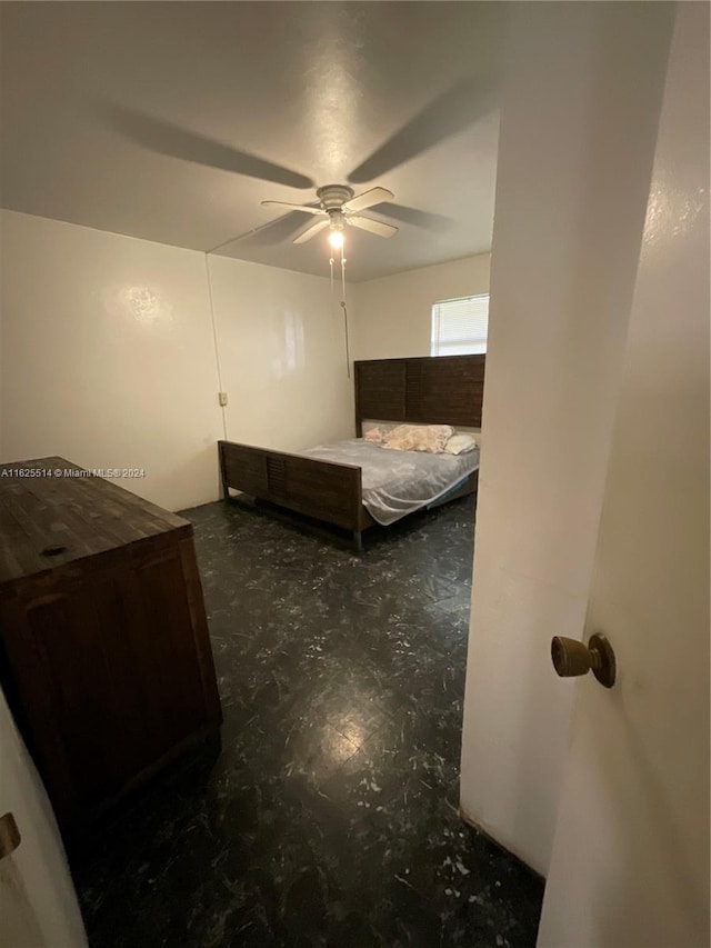 bedroom with ceiling fan and concrete floors