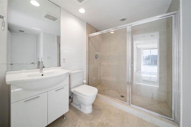 bathroom featuring vanity, an enclosed shower, and toilet