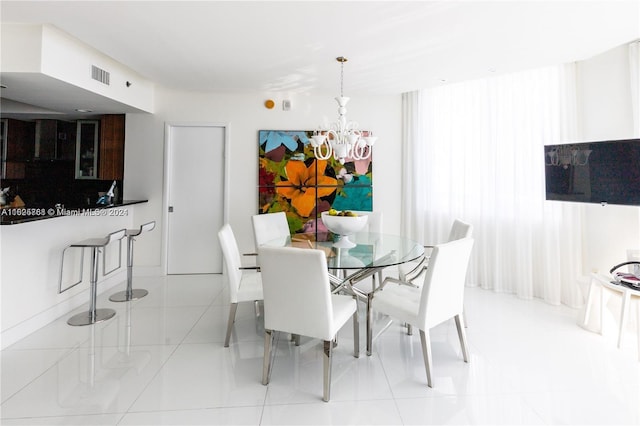 dining room with an inviting chandelier and light tile patterned floors