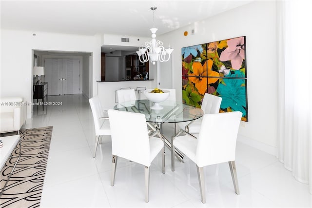 dining area featuring a notable chandelier and light tile patterned floors