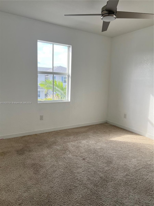 empty room with carpet floors and ceiling fan