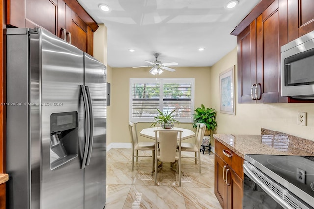 kitchen featuring ceiling fan, light stone countertops, and appliances with stainless steel finishes