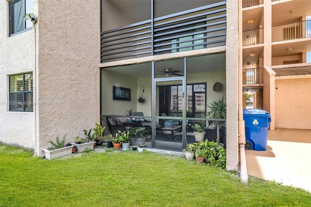 entrance to property with a balcony and a lawn