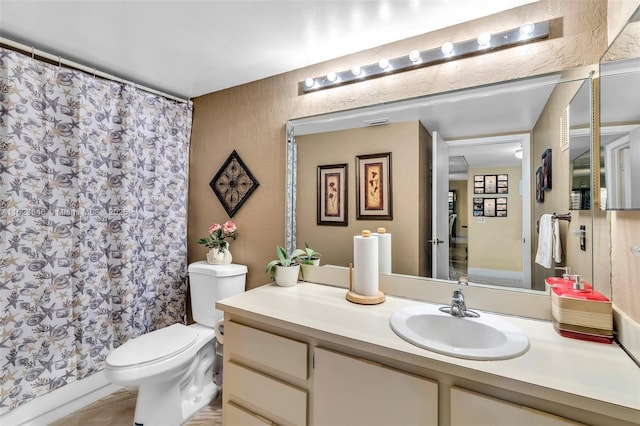 2606 NW 104th Ave Unit 106, Sunrise, FL 33322 - full bathroom with vanity, a textured wall, toilet, and a shower with curtain