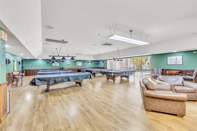 rec room featuring light hardwood / wood-style floors, a textured ceiling, and pool table