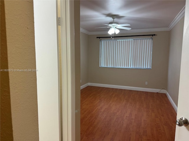 unfurnished room with ornamental molding, hardwood / wood-style flooring, and ceiling fan