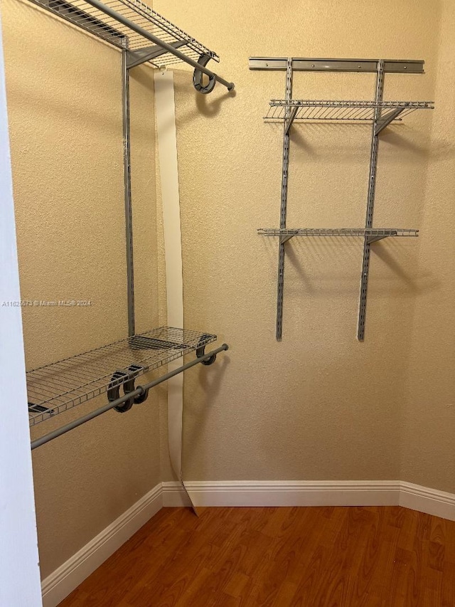 spacious closet featuring hardwood / wood-style floors