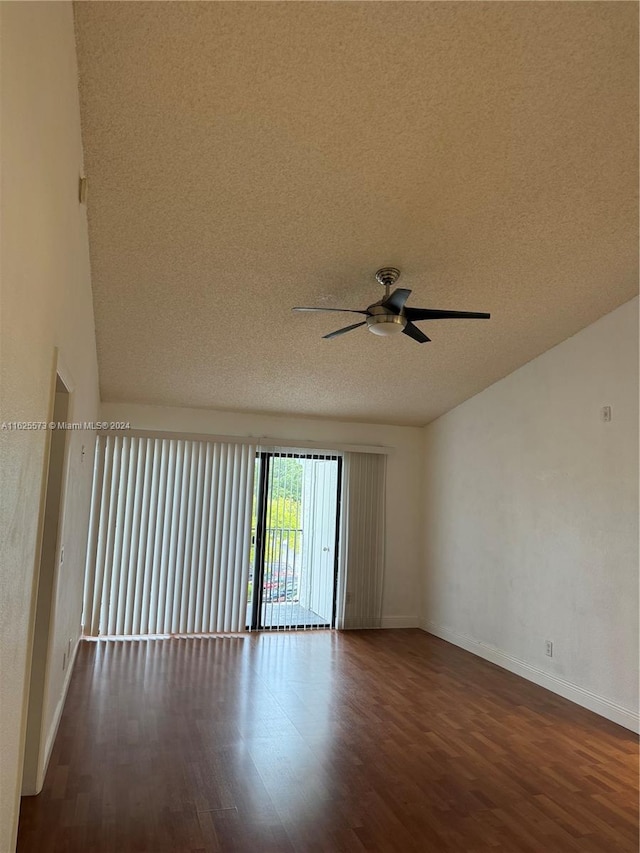 spare room featuring ceiling fan, dark hardwood / wood-style floors, and a textured ceiling