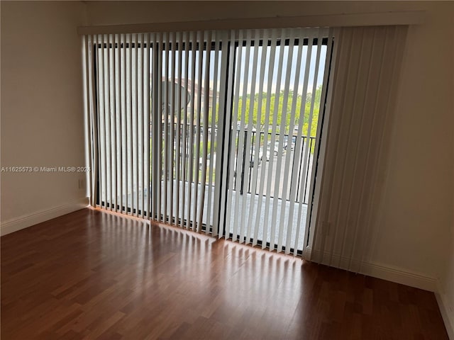 unfurnished room with wood-type flooring