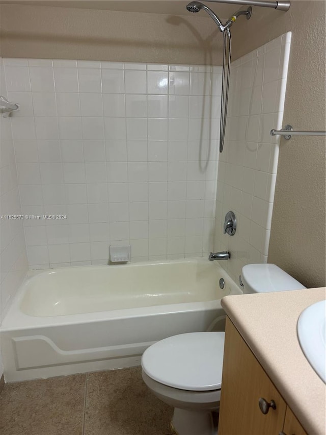 full bathroom featuring vanity, tile patterned flooring, toilet, and tiled shower / bath combo