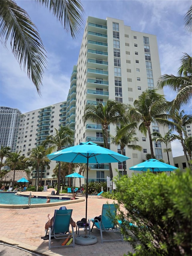 view of building exterior featuring a community pool