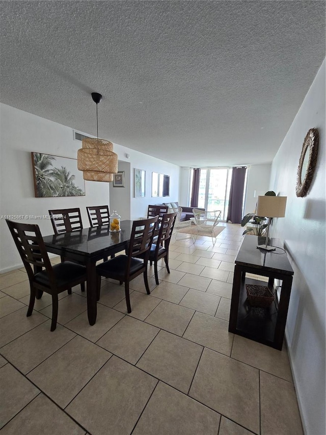 tiled dining area with a textured ceiling