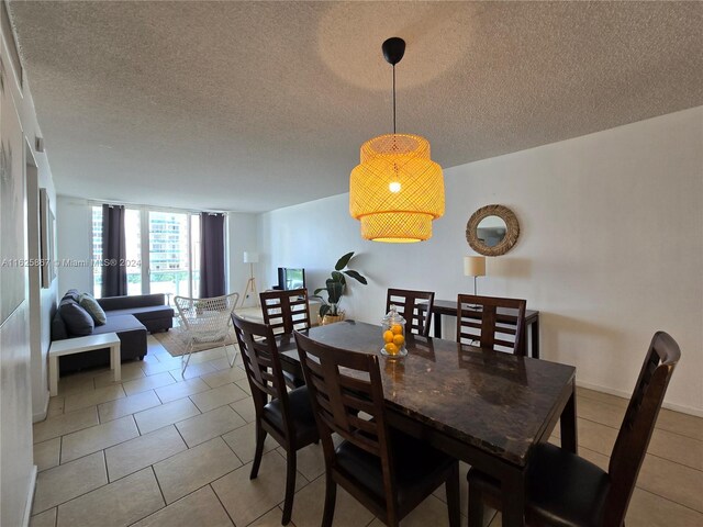 tiled dining area with a wall of windows and a textured ceiling