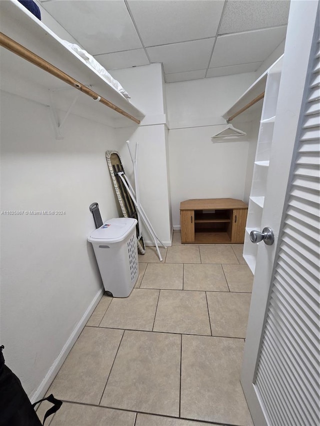 walk in closet featuring a paneled ceiling and light tile patterned floors