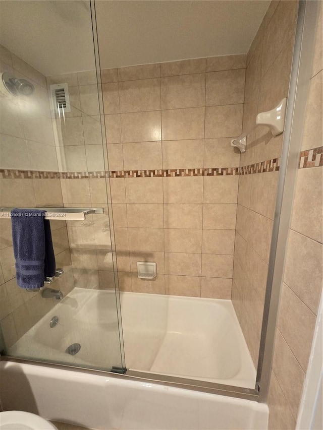 bathroom featuring shower / bath combination with glass door