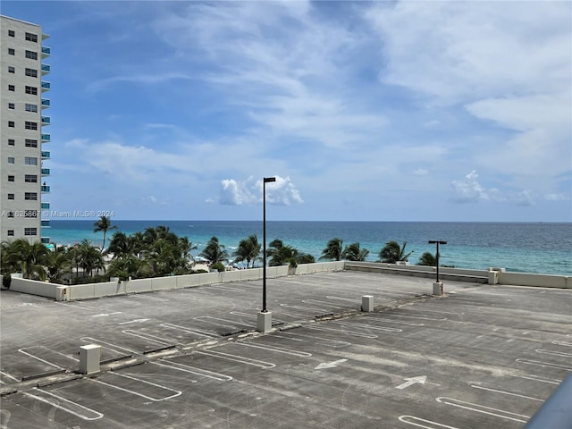 view of parking / parking lot featuring a water view