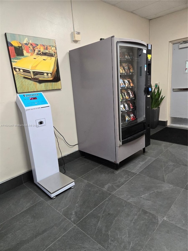 interior space with fridge and a drop ceiling