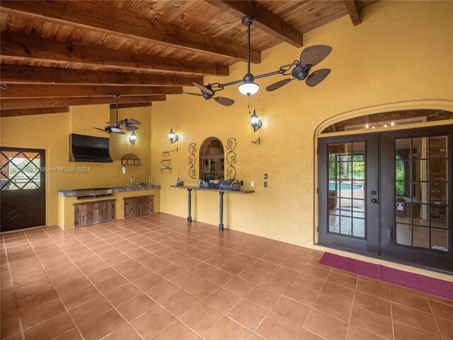 unfurnished living room with tile patterned flooring, french doors, and ceiling fan